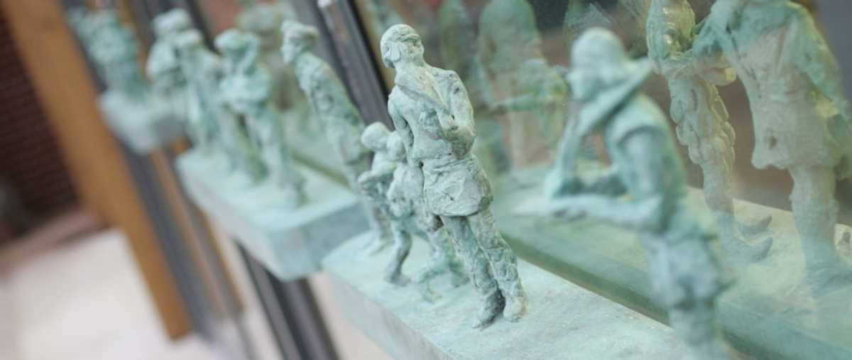 Figures on the doors leading into the Clore Learning Centre reference the history of the site at Hampton Court Palace, Surrey. Historic Royal Palaces